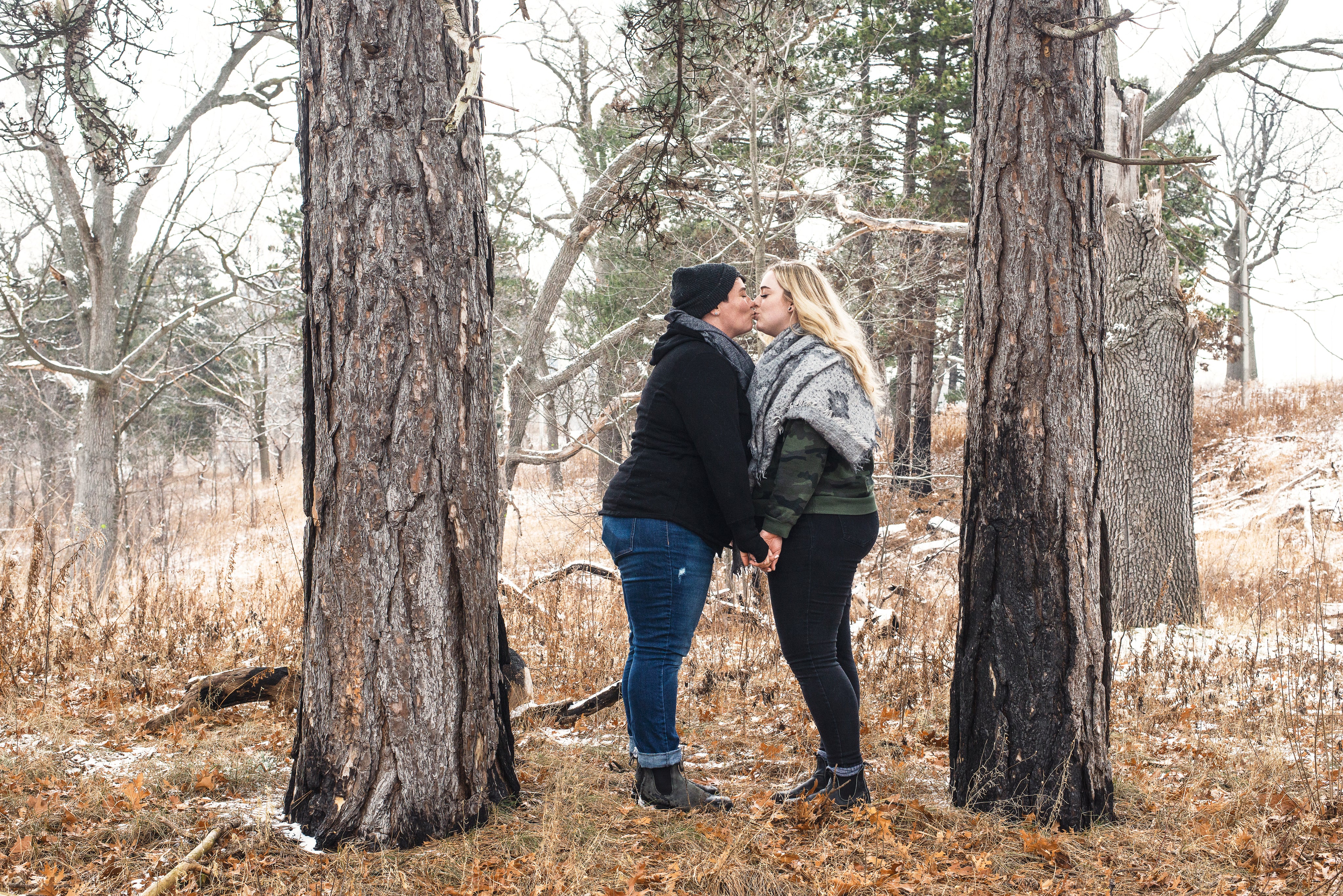 files/two-women-sharing-a-kiss-in-the-woods.jpg